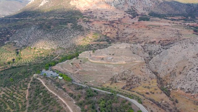 Aerial view by drone of archaeological site of ancient citadel of Mycenae from the parking lot, north-eastern Peloponnese, Greece.