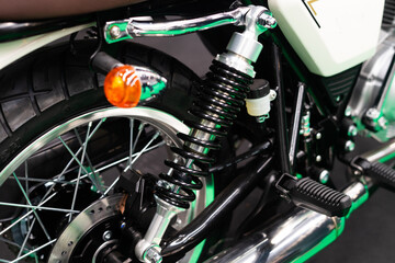 Detail of the suspension on the rear wheel of a custom motorbike