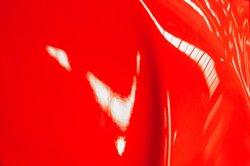 Red metallic painting on a curved surface