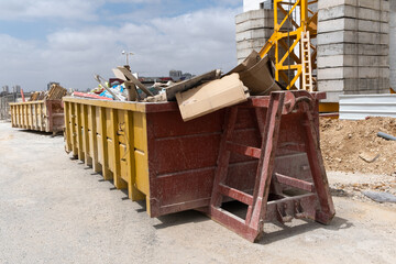 huge heap on metal Big  Overloaded dumpster waste container filled with construction waste, drywall...