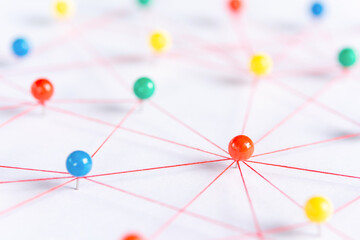 Linking entities, Blockchain, social media, Communications Network, The connection between the two networks. Network simulation on paper linked together by yarn