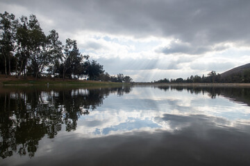 A Quiet Lake with Clouds Reflecting on the Surface