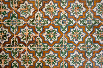 Ornamental medieval ceramic tiles of walls in Nasrid Palaces in the Alhambra palace Granada,...