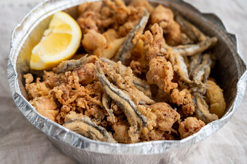 Spanish sea food, cripsy deep fried baby octopus, fish, calamari rings served with lemon