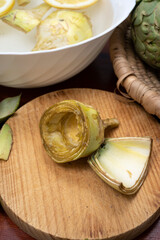 Cooking of green heads of artichokes plants, how to peel artichoke