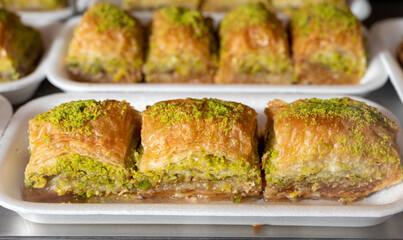 Turkish or arabic sweet dessert, baklava made from filo pastry, filled with chopped pistachio nuts and sweetened with syrup or honey.