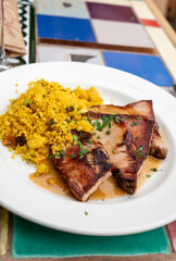 Andalusian cuisine, spicy cous-cous with grilled pork ham filet