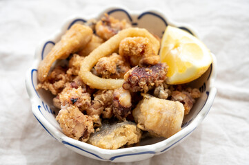 Spanish sea food, cripsy deep fried baby octopus, fish, calamari rings served with lemon