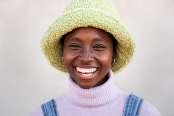 Outdoor portrait of a cheerful black woman looking at the camera smiling. Close up of a happy human face. Concept of people and emotions.