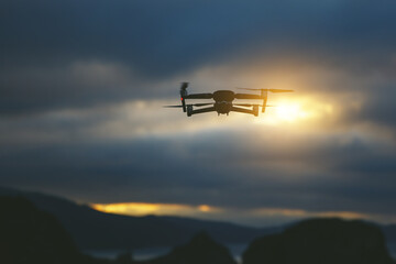 Fototapeta na wymiar Foldable drone copter flying with a digital camera in mountains.