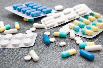 Different colors medicine or tablets on table - medical health care concept	