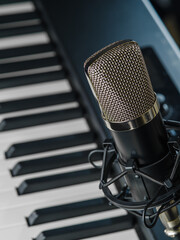 Macro shot. MIDI keyboard, synthesizer and microphone. Music, singing, radio, rehearsals, concerts, music festivals, tours. There are no people in the photo. Advertising, banner.