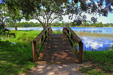 Wooden pedestrian bridge towards the lake