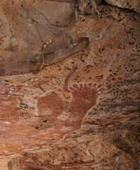 Under the roof of a sandstone ledge where old rock paintings are found.