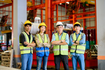 Four Asian engineer standing for group of portrait in metal sheet factory