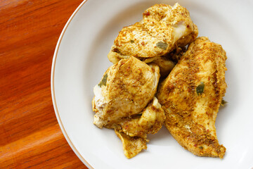 Closeup steamed chicken breast meat mixed with Thai spice herbs on dish. Concept : healthy food. Good for diet. Weight control. Delicious Thai food style.         