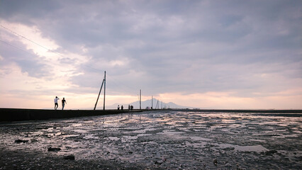 Outdoor lights extending to the tidal flats at dusk