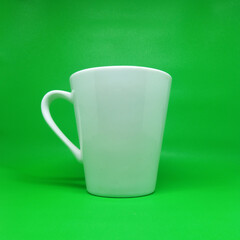 White cup on green background
