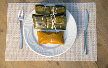 Dominican Pasteles en Hoja is a plantain and tuber dough filled with meat wrapped in plantain...