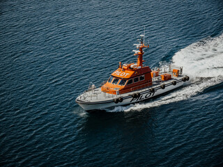 A Harbor Pilot Boat meets a ship to retrieve the Harbor Pilot who has supervised the departure...