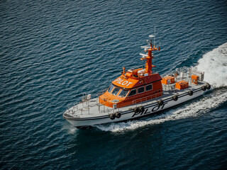 A Harbor Pilot Boat meets a ship to retrieve the Harbor Pilot who has supervised the departure...