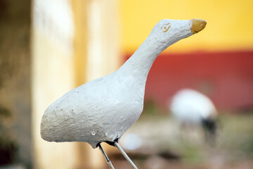 Portrait of a statue of a duck with broken leg. statue. Animal sculpture