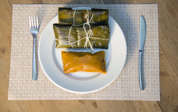 Dominican Pasteles en Hoja is a plantain and tuber dough filled with meat wrapped in plantain leaves. It is similar to Mexican tamales
