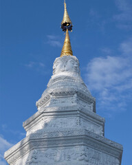 Fototapeta premium Buddhist old traditional stupa on the blue sky background in temple in old city Chiang Mai Thailand 