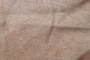 fabric grunge background, real cotton denim brown, wrinkled, frayed, close