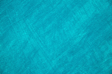 white artistic canvas of coarse weave covered with a thin layer of turquoise primer close-up, toning, free space