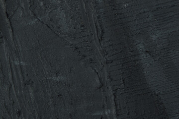 abstract background: black textured plaster, close