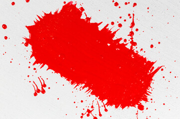 thick red acrylic paint applied in an uneven patch on a flat surface