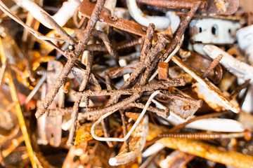 Diverse old rusty scrap metal from small items close-up
