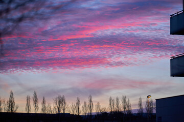 Dramatic view of the sky with red clouds from the city at sunset