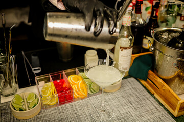 Barman making the daiquiri cocktail on the bar counter