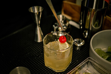 Barman making the bourbon sidecar cocktail on the bar counter