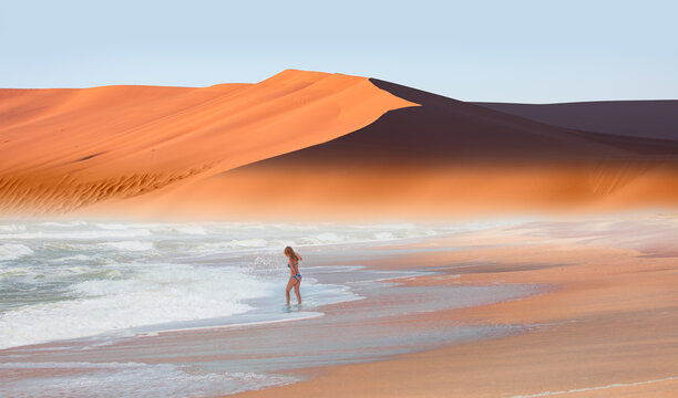 Girl on tropical beach - Beautiful woman in bikini enjoy a swim in the sea - Namib desert with Atlantic ocean meets near Skeleton coast - 
Namibia, South Africa