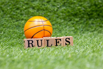 Basketball rules are on green grass. The rules of basketball are the rules and regulations that govern the play, officiating, equipment and procedures of basketball. While many of the basic rules are  - obrazy, fototapety, plakaty