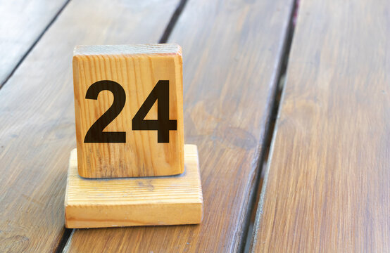 Wooden priority number 24 on a plank tab
