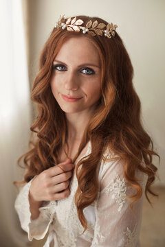 Fairy tale portrait of a beautiful ginger curly princess with a golden tiara