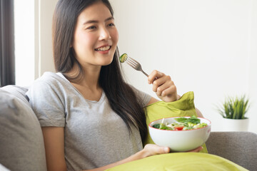 eat healthy food on wellness lifestyle. Beauty young woman eating salad as a breakfast.