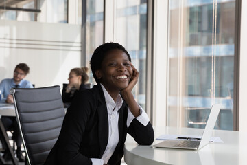 Happy millennial Black employee woman office head shot portrait. Cheerful young businesswoman...
