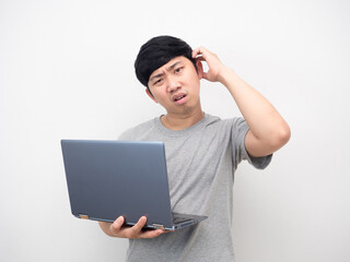 Asian man holding laptop gesture bored looking at camera