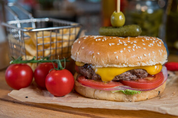 A burger with veal, lettuce leaves, tomatoes and pickles