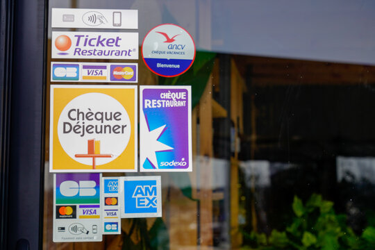 ticket Restaurant brand cheque dejeuner logo and text sodexo sign front of restaurant windows door with card sticker amex CB visa