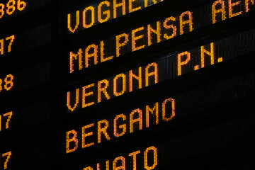 Obraz premium Close-up of a departure board with different italian destinations in Central Station of Milano, Italy
