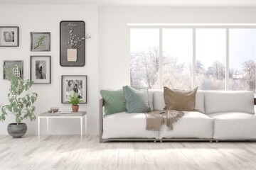 White living room with sofa and winter landscape in window. Scandinavian interior design. 3D illustration