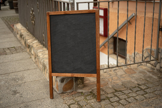 Blank wooden menu. Sinboard on the street. Empty menu board stand