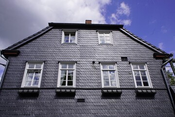Old historic buildings from the Middle Ages, covered with slabs of slate to protect against heat and cold. Goslar, Germany.