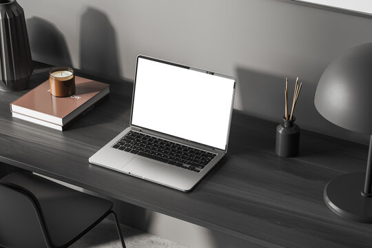 Office interior with laptop mockup screen on wooden desk, top view